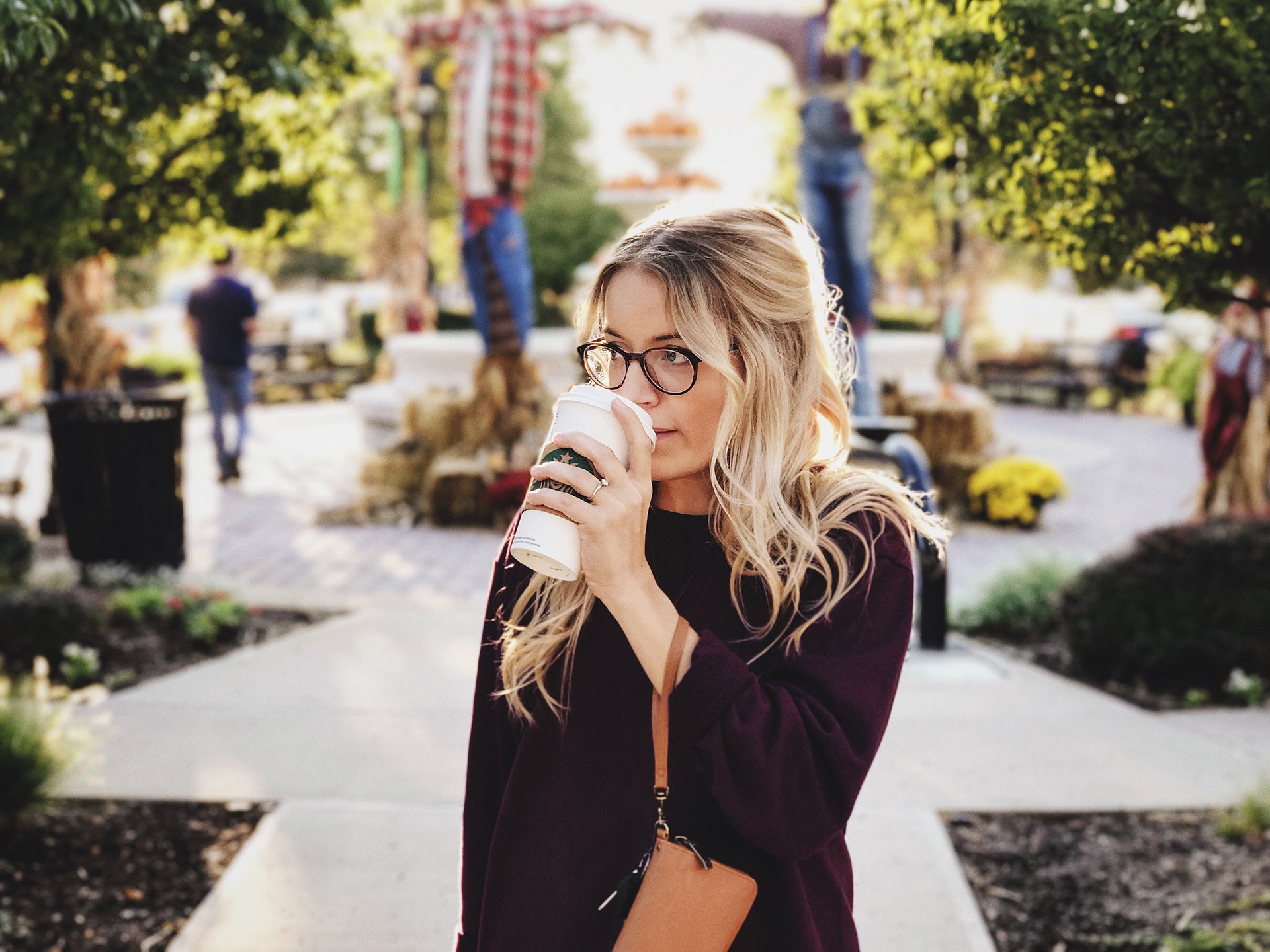Woman drinking coffee on a street